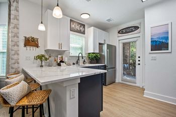 Gourmet kitchen with quartz countertops and designer italian tile backsplashes